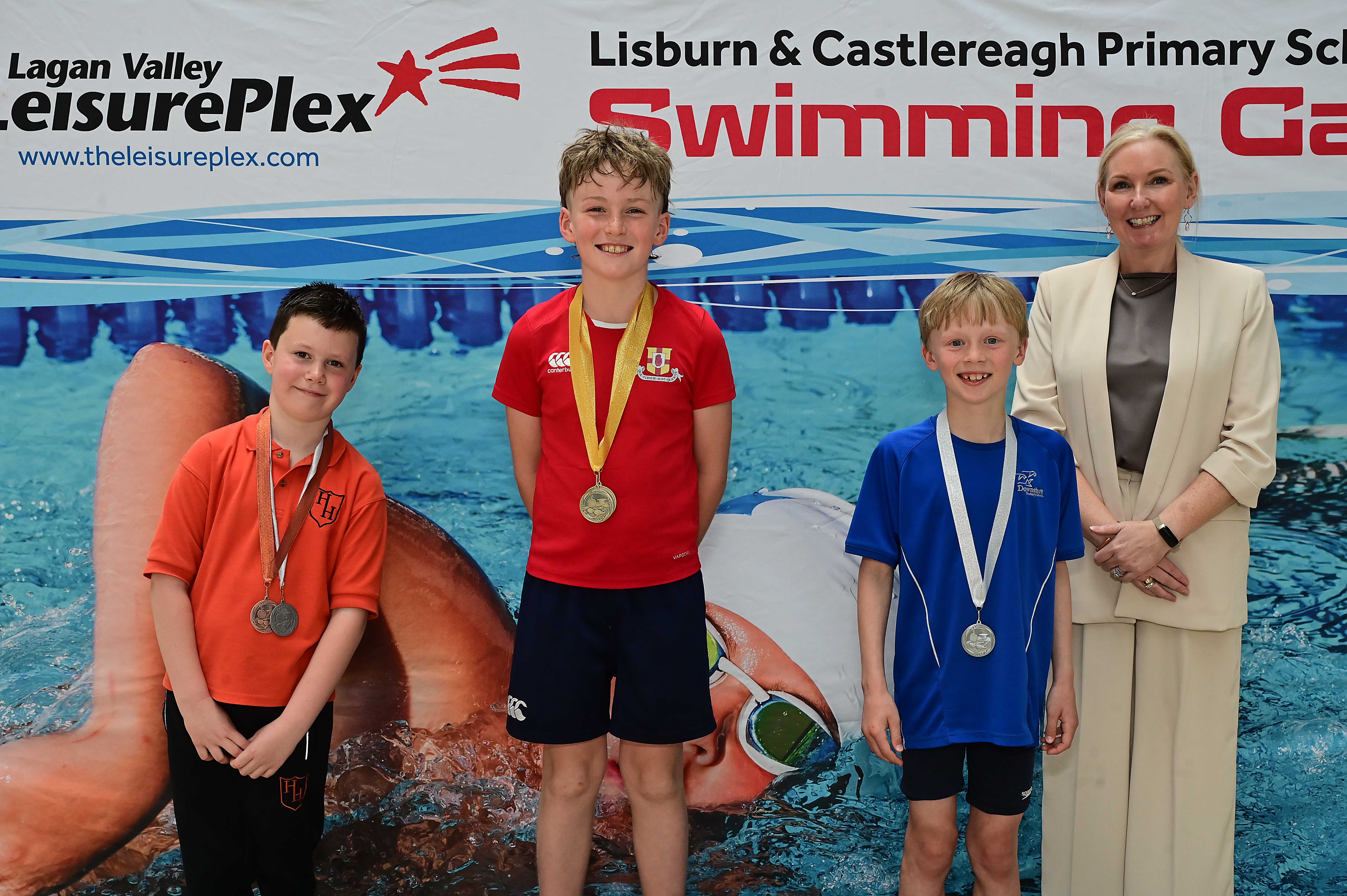 Louise Moore, Director of Leisure & Community Wellbeing presents Event 11 Freestyle to Club swimmers: 1st Finn McKeown (Friends’ Prep), 2nd Tom McGonigle (Downshire) and 3rd Theo Frizelle (Harmony Hill) 