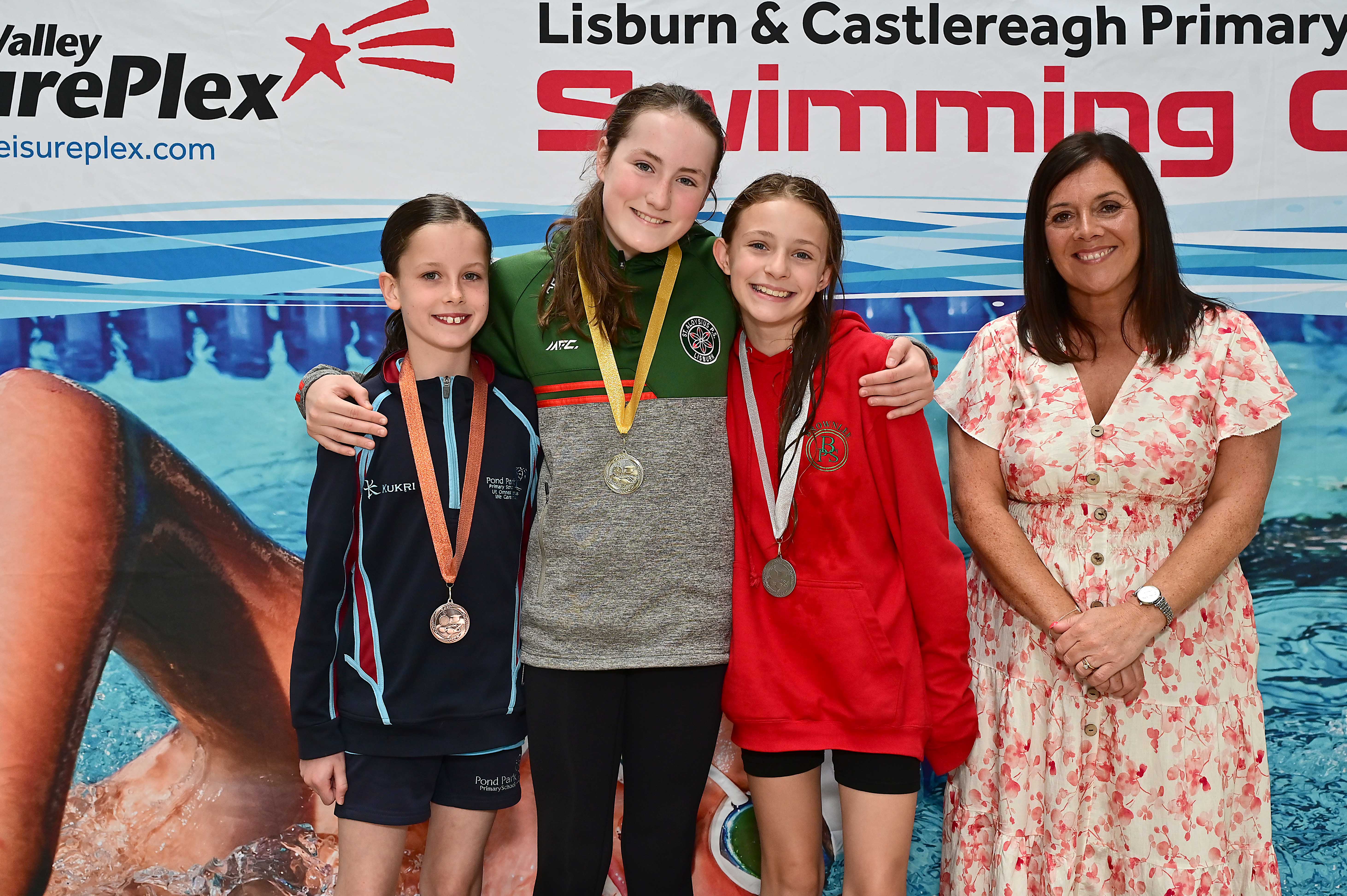 Chair of Communities and Wellbeing Committee, Councillor Sharon Lowry presents Event 19 Backstroke (Club):1st   Abbie Brown (St Aloysius), 2nd   Gracie Kelly (Brownlee) and 3rd Carrianna Tinsley (Pond Park) 