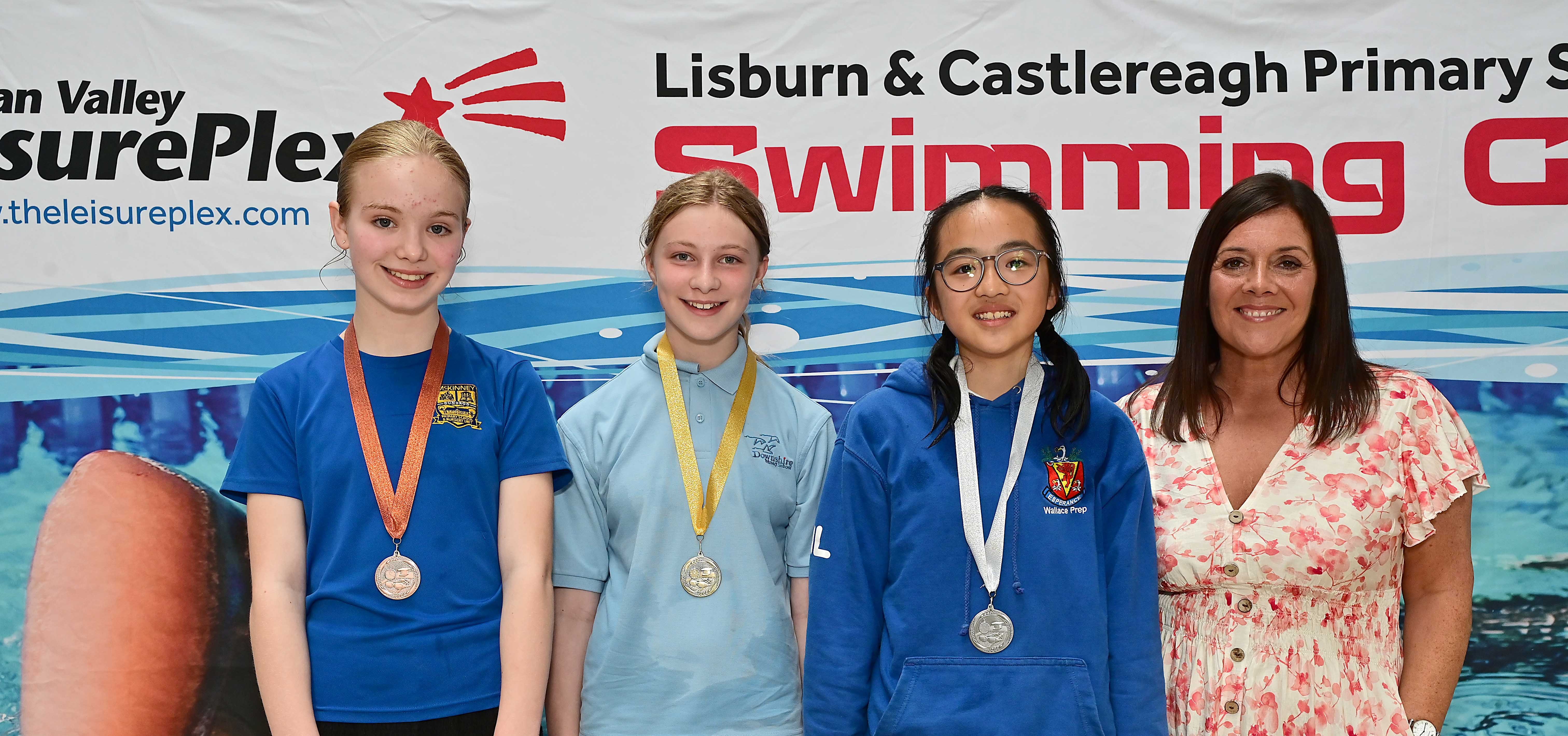 Chair of Communities and Wellbeing Committee, Councillor Sharon Lowry presents Event 19 Backstroke (Non-club): 1ST Mia Lovell (Downshire), 2nd Isla Lee (Wallace Prep) and 3rd Martha Dunlop (McKinney)  