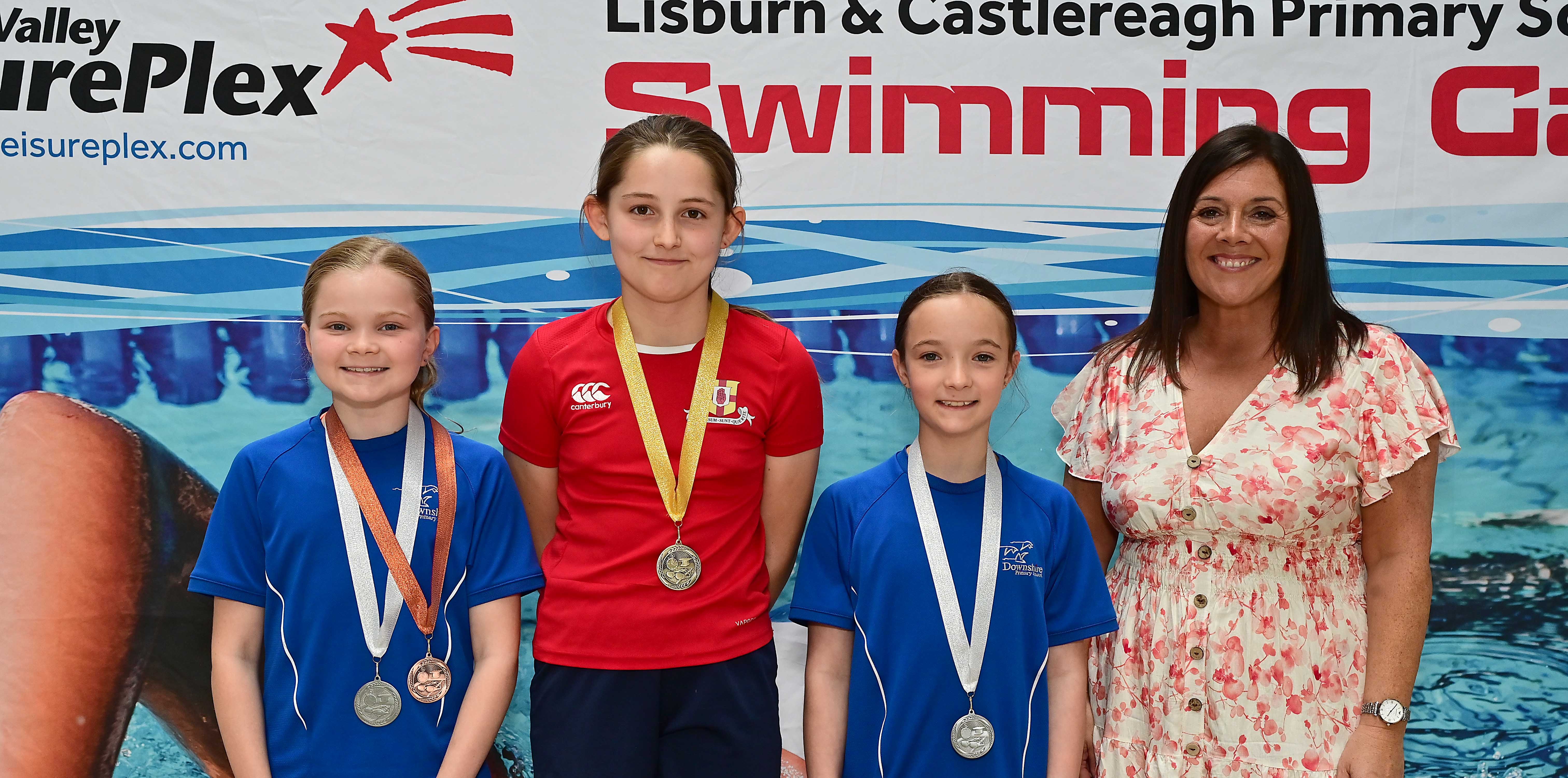 Chair of Communities and Wellbeing Committee, Councillor Sharon Lowry presents  Event 21 Breaststroke (Club): 1st Ana Niblock (Friends’ Prep), 2nd Freya Douglas (Downshire) and  3rd Jessica McAleer  (Downshire) 
