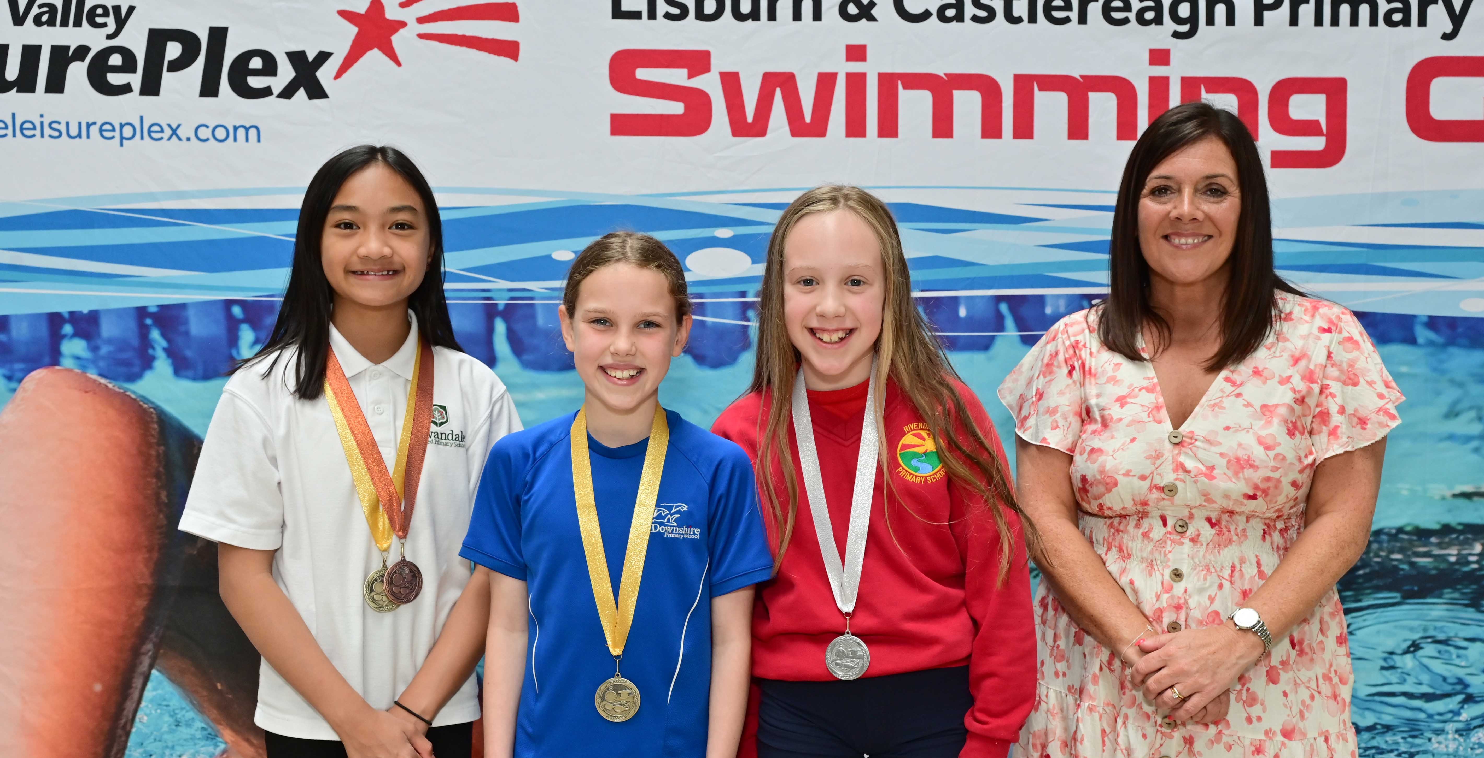 Chair of Communities and Wellbeing Committee, Councillor Sharon Lowry presents Event 25 Freestyle (Club): 1st Olivia Spence (Downshire), 2nd Leah Blair (Riverdale) and 3rd Alexandra Quibael  