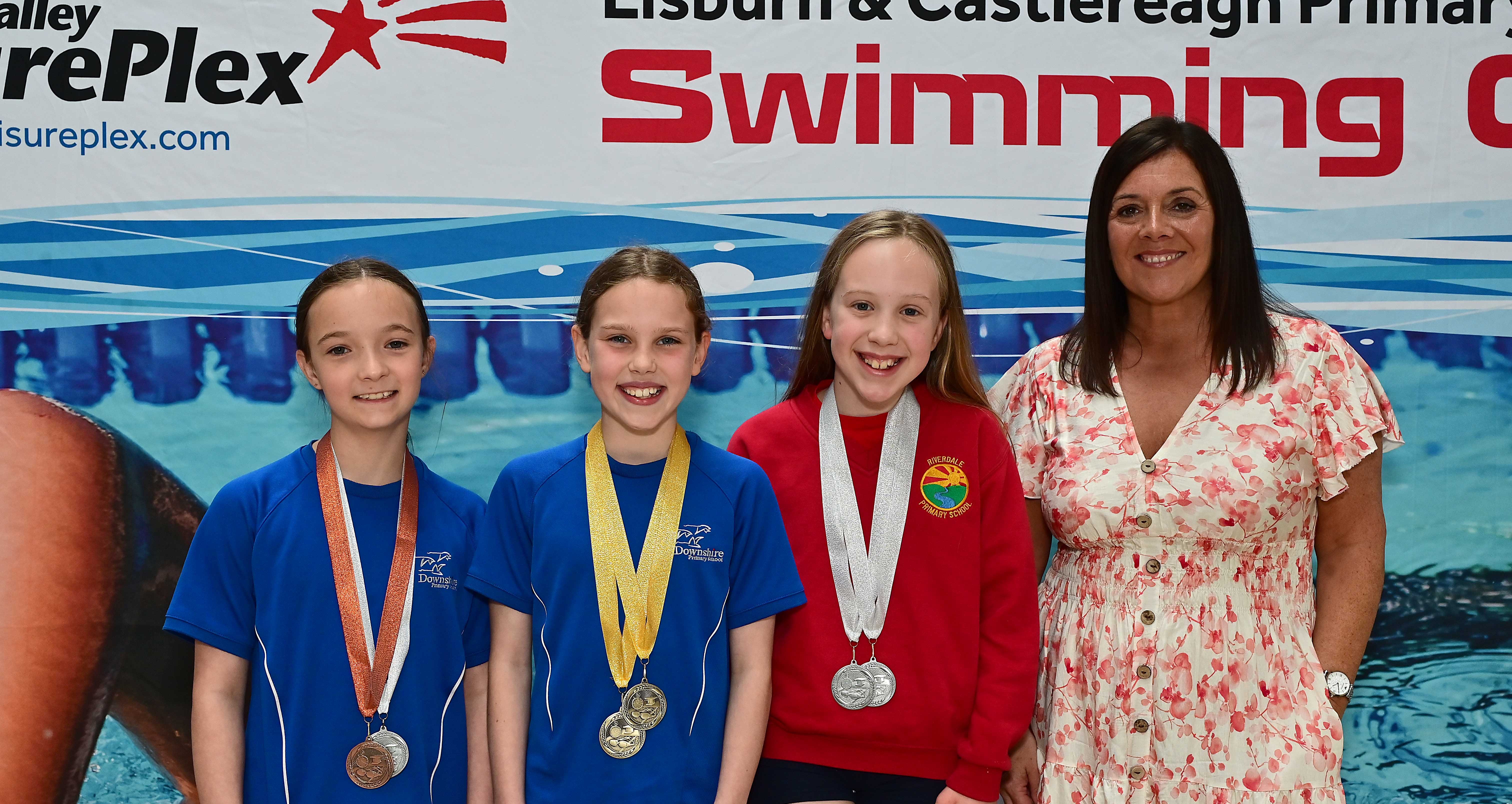 Chair of Communities and Wellbeing Committee, Councillor Sharon Lowry presents Event 29 Butterfly (Club):1st Olivia Spence (Downshire), 2nd Leah Blair (Riverdale) and 3rd Freya Douglas (Downshire) 