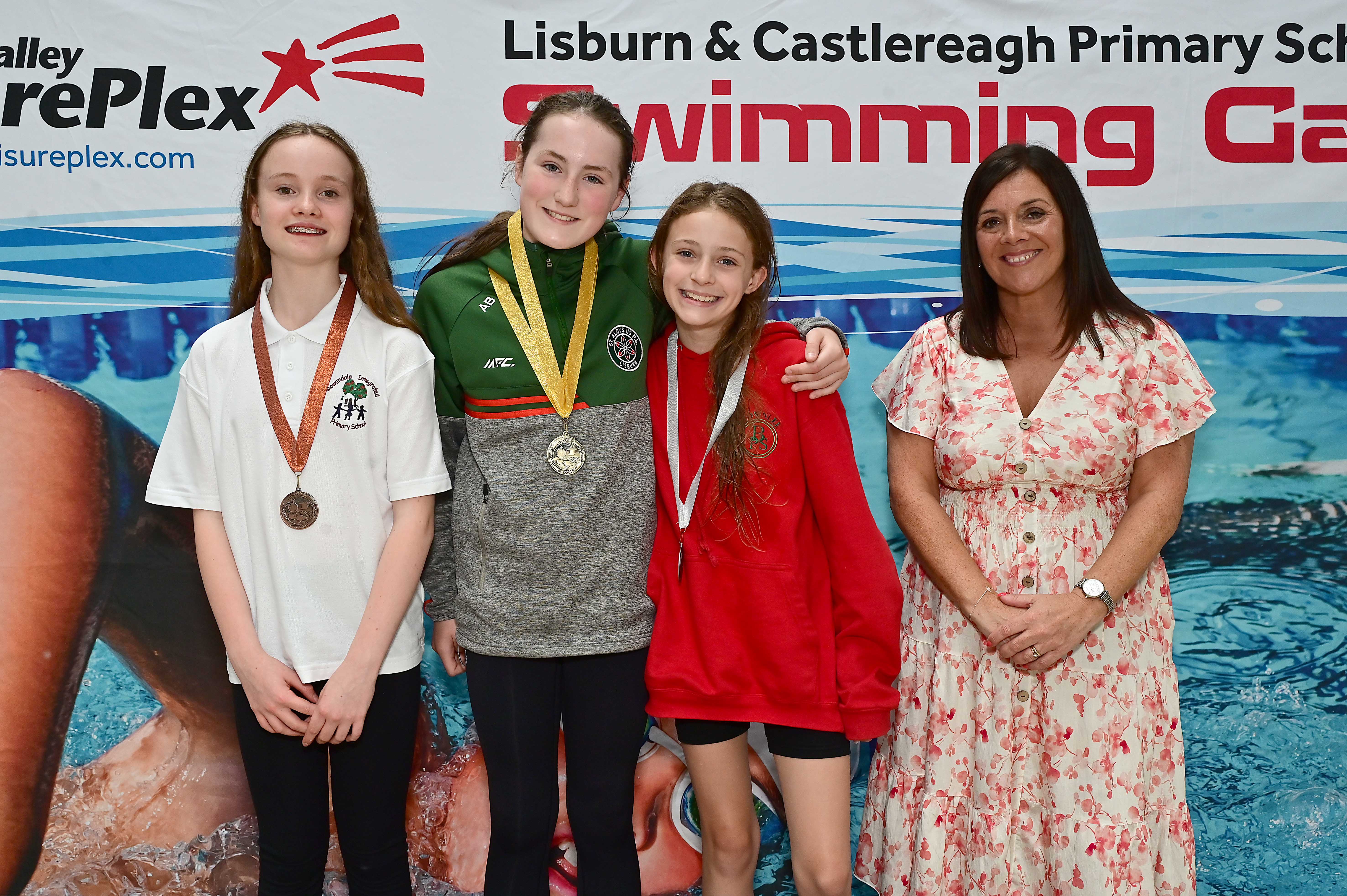 Chair of Communities and Wellbeing Committee, Councillor Sharon Lowry presents Event 31 Butterfly (Club):  1st Abbie Brown (St Aloysius),  2nd Gracie Kelly (Brownlee) and 3rd Pippa Lowry (Rowandale)  