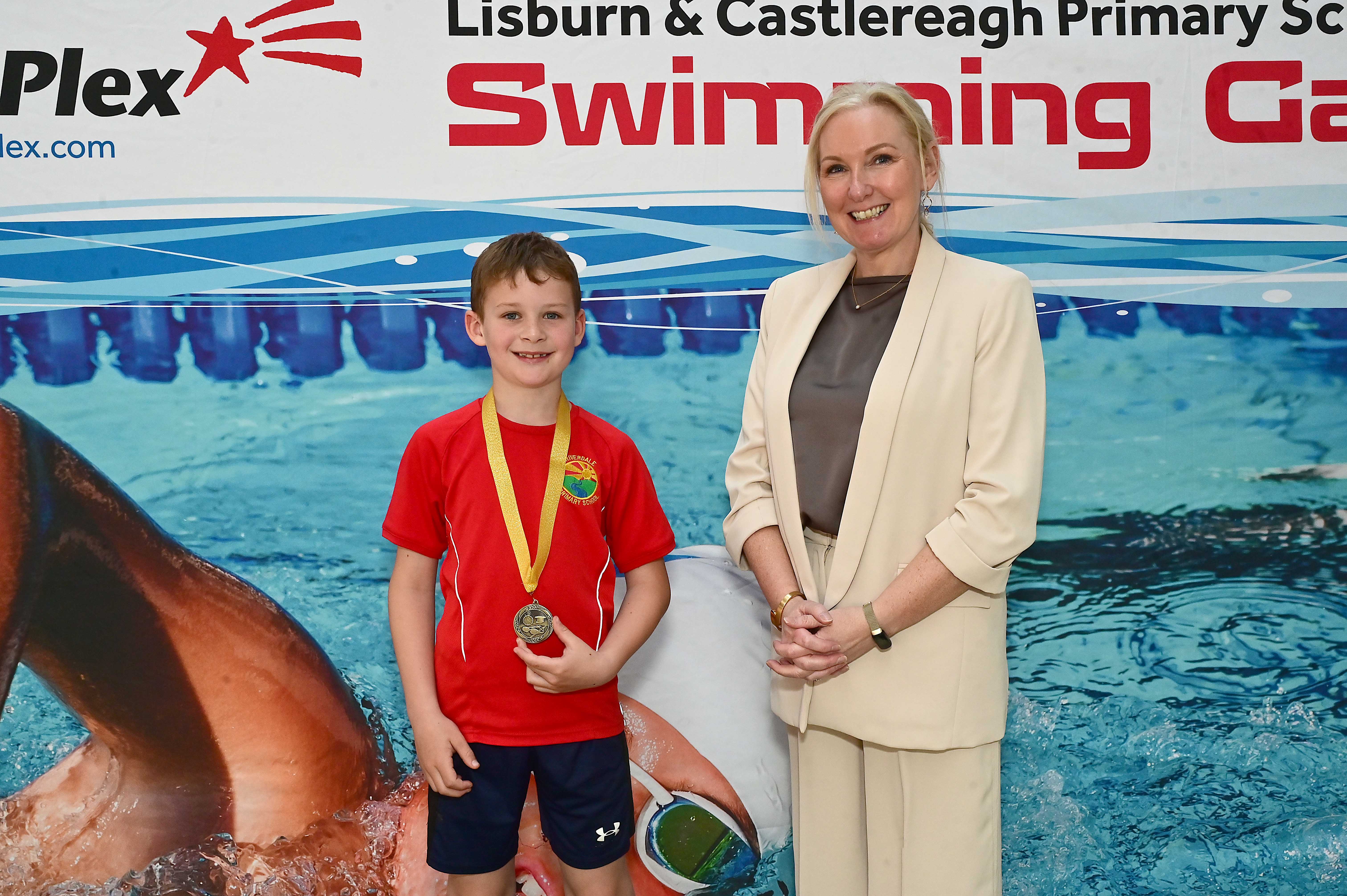 Louise Moore, Director of Leisure & Community Wellbeing presents Event 5 Breaststoke to Club Swimmer, Daniel Kennedy (Riverdale) in 1st place. 