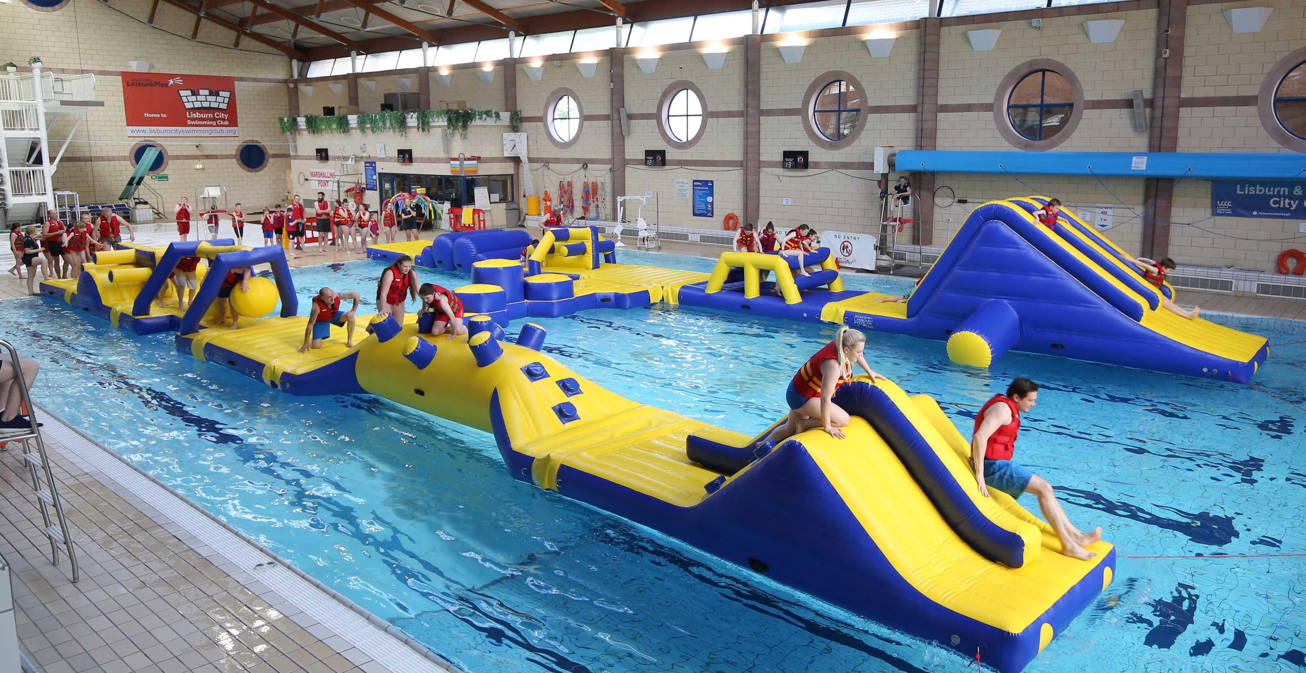 Kids climbing over inflatable pool activity