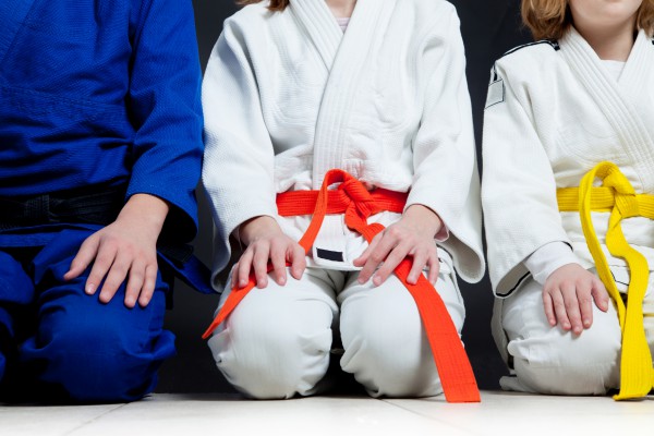 Kids sitting in Karate outfits