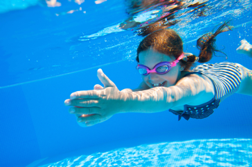 Girl underwater with swimming goggles