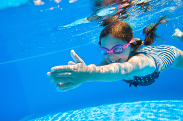 Child Swimming with swimming goggles on