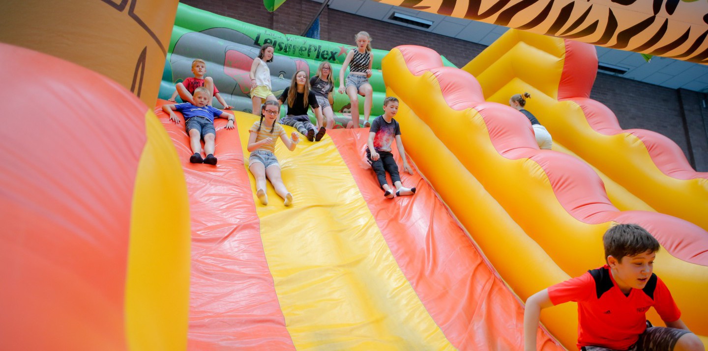 Children on bouncy castle slide