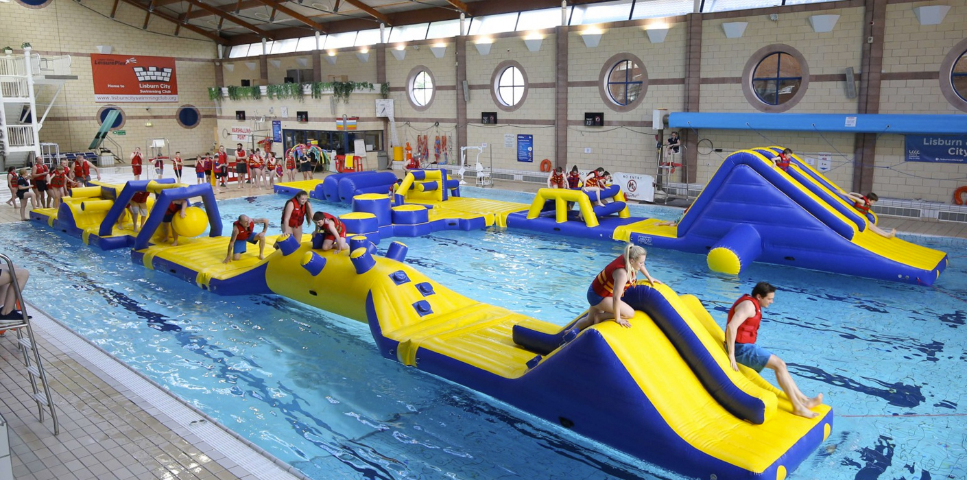 Children on inflatable water assault course