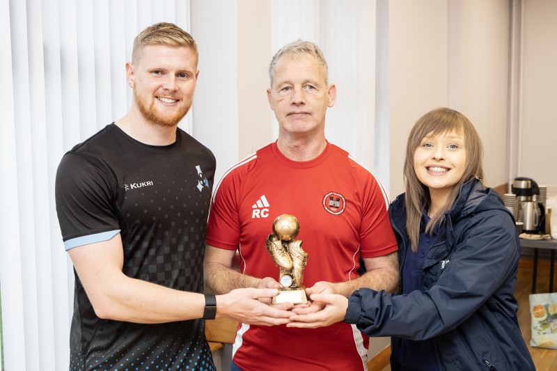 Danny Magill from Community Sports Network and Lisburn & Castlereagh City Council’s Events Co-ordinator, Lyndsay McVeigh, pictured with ‘Player of the Tournament’, Robert Campbell from Hillsborough Walking Football Team.